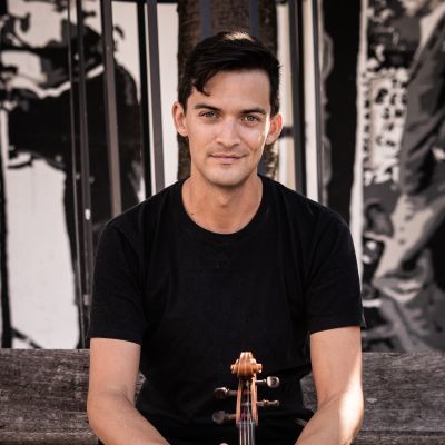 Photo of Stephen Upshaw holding a violin